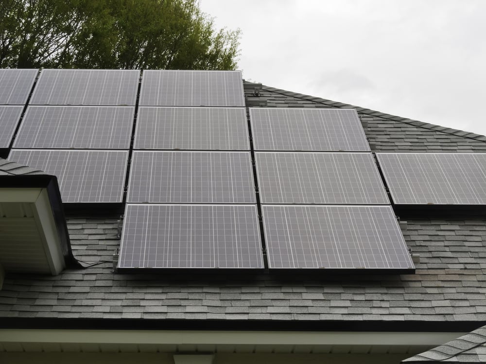 roof with solar panels saving money on electricity